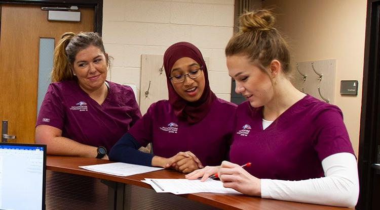 Nursing students reviewing coursework.